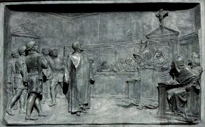 Giordano Bruno vor der Inquisitionskommision. Historisierendes Relief von Ettore Ferrari (1848–1929), Campo de' Fiori, Rome. Quelle: Jastrow / Wikimedia Commons